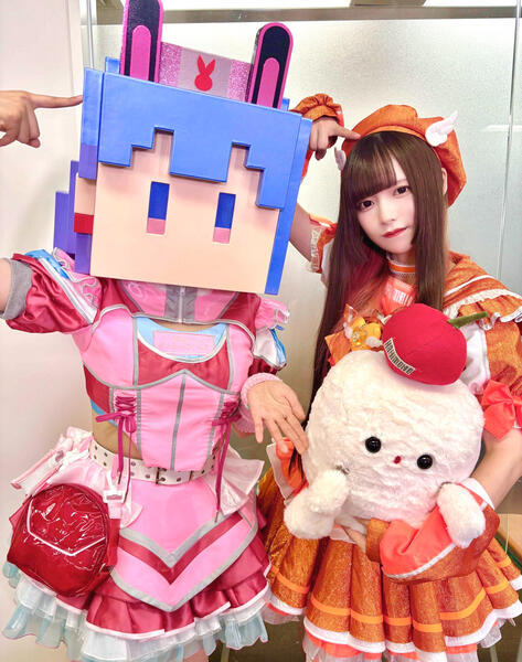 Nonoka in her pixel head with the band&#39;s friend and many times collaborator, Yuma from NANIMONO