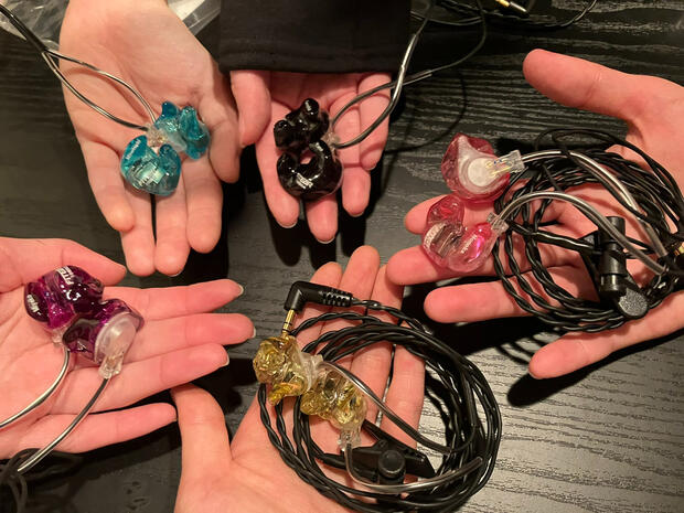 Picture of the band members&#39; custom in-ear monitors
