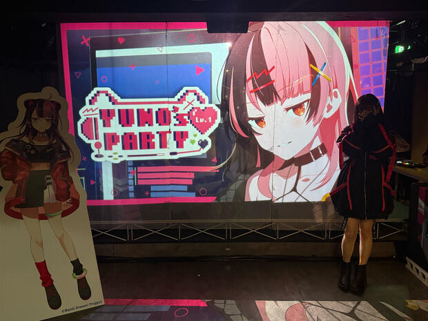 Yuno on stage with her cardboard cutout